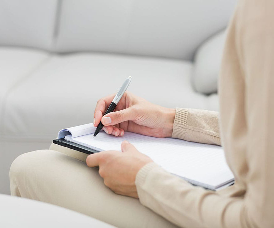 Psychologist writing on clipboard